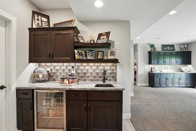 2925 Pine Hill Trce, Coralville, IA 52241 - indoor wet bar featuring wine cooler, tasteful backsplash, recessed lighting, light colored carpet, and baseboards
