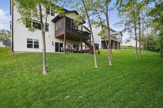 2925 Pine Hill Trce, Coralville, IA 52241 - back of house featuring a sunroom, cooling unit, a lawn, and a wooden deck