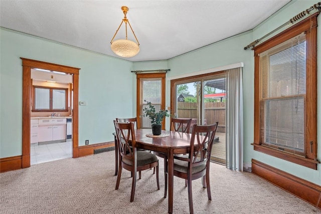 100 E Welsh St, Williamsburg, IA 52361 - dining room featuring light carpet and baseboards