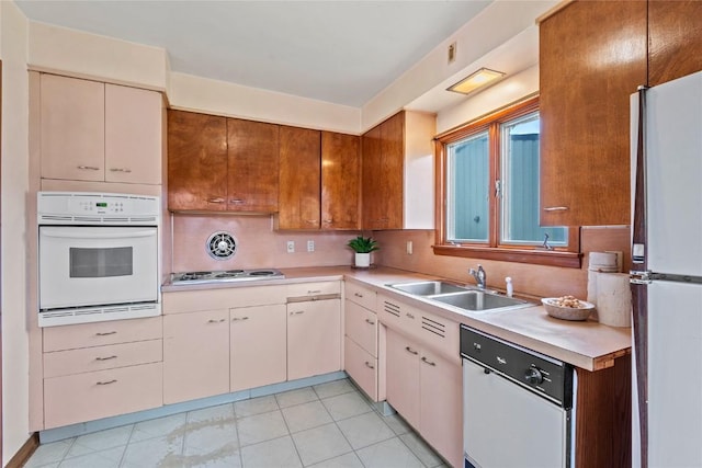 100 E Welsh St, Williamsburg, IA 52361 - kitchen featuring white appliances, a sink, light countertops, and tasteful backsplash