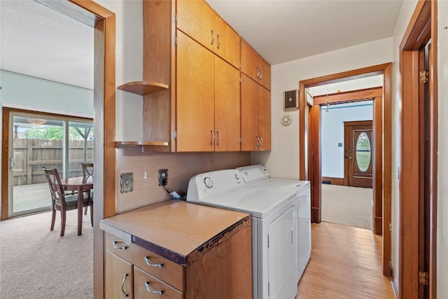 100 E Welsh St, Williamsburg, IA 52361 - laundry room with cabinet space, washer and dryer, and light colored carpet