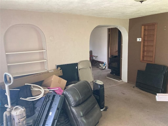 1403 W 3rd St, Vinton, IA 52349 - carpeted living area with arched walkways and a textured ceiling