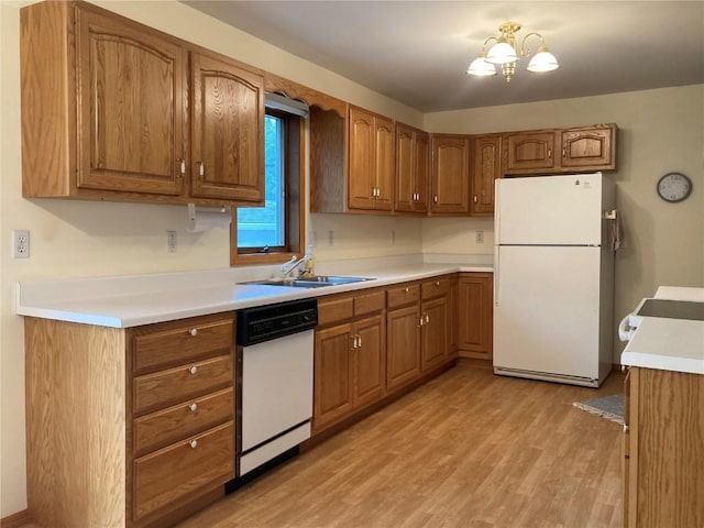 202 S 9th Ave, Vinton, IA 52349 - kitchen featuring white appliances, a sink, and brown cabinetry