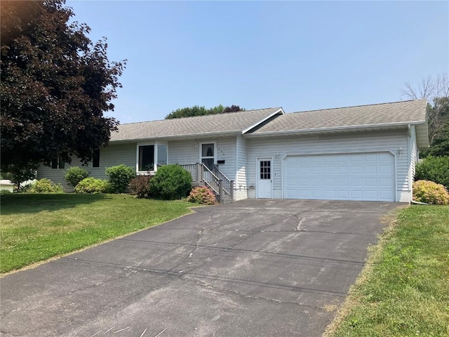 202 S 9th Ave, Vinton, IA 52349 - ranch-style home with a front yard, a garage, asphalt driveway, and a shingled roof