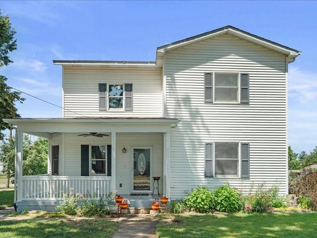 433 S Iowa St, Solon, IA 52333 - traditional-style house with covered porch, a ceiling fan, and a front yard