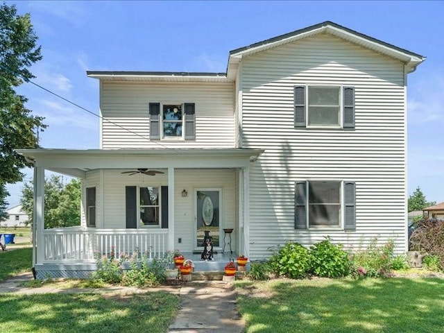 433 S Iowa St, Solon, IA 52333 - traditional-style home with covered porch, a front yard, and a ceiling fan