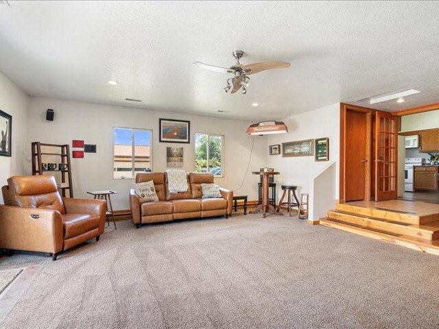 433 S Iowa St, Solon, IA 52333 - living area with a ceiling fan, light carpet, a textured ceiling, and recessed lighting
