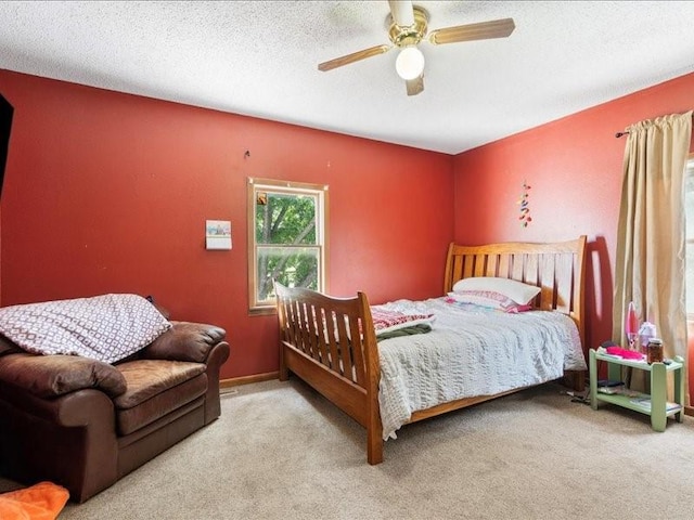 433 S Iowa St, Solon, IA 52333 - carpeted bedroom featuring a ceiling fan and a textured ceiling