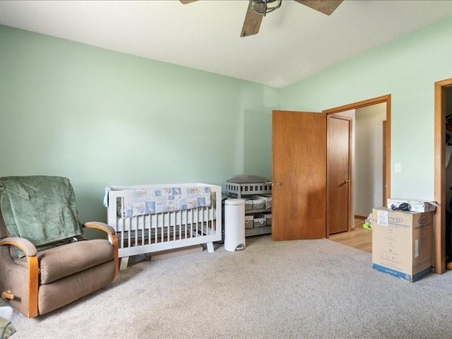 433 S Iowa St, Solon, IA 52333 - carpeted bedroom with vaulted ceiling, a ceiling fan, and a nursery area