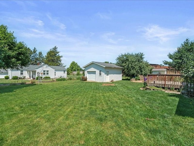 433 S Iowa St, Solon, IA 52333 - view of green lawn featuring a detached garage, an outbuilding, and a wooden deck