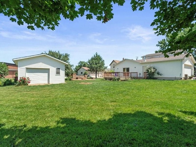 433 S Iowa St, Solon, IA 52333 - view of grassy yard featuring a detached garage, a wooden deck, and an outdoor structure