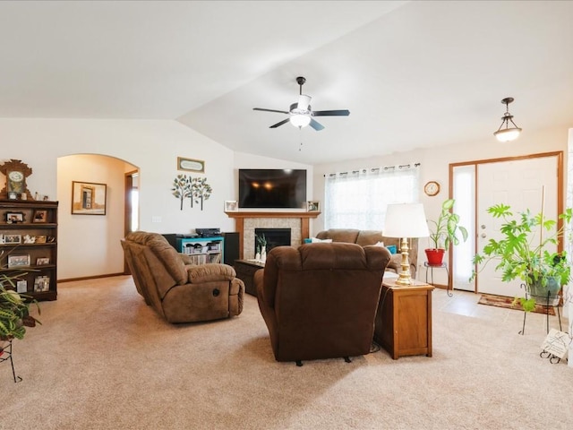4408 Hastings Dr, Marion, IA 52302 - living room with arched walkways, ceiling fan, lofted ceiling, a tile fireplace, and light carpet