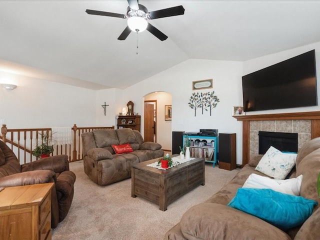 4408 Hastings Dr, Marion, IA 52302 - living area featuring vaulted ceiling, a ceiling fan, arched walkways, light carpet, and a tiled fireplace