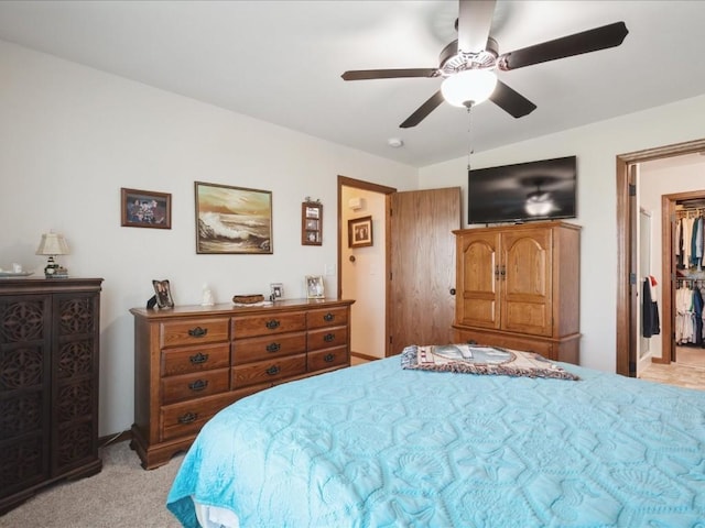 4408 Hastings Dr, Marion, IA 52302 - bedroom with light colored carpet, a spacious closet, ceiling fan, and baseboards