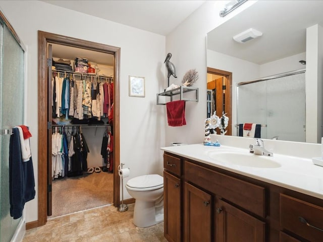 4408 Hastings Dr, Marion, IA 52302 - bathroom featuring a walk in closet, vanity, a stall shower, toilet, and baseboards
