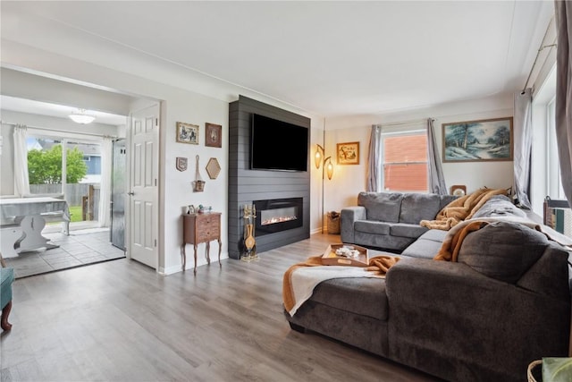 3007 Ravenwood Ter NW, Cedar Rapids, IA 52405 - living room with a large fireplace, wood finished floors, and baseboards