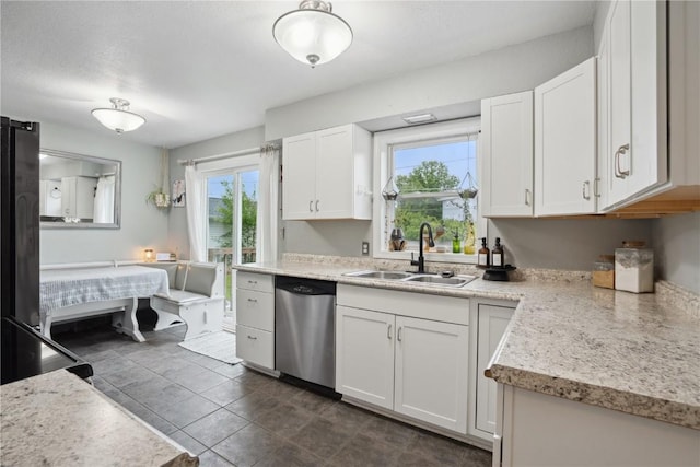 3007 Ravenwood Ter NW, Cedar Rapids, IA 52405 - kitchen featuring dishwasher, a sink, and light countertops