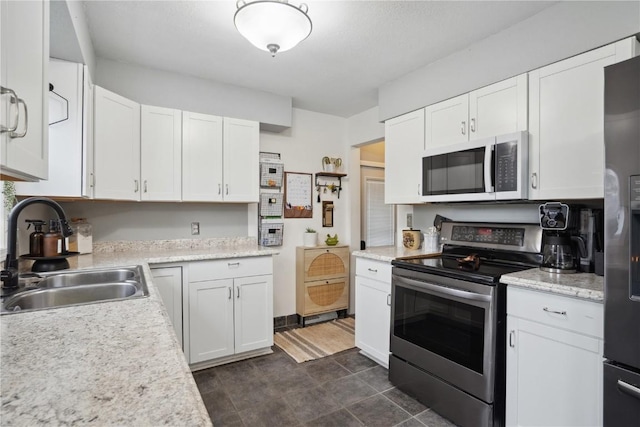 3007 Ravenwood Ter NW, Cedar Rapids, IA 52405 - kitchen with stainless steel appliances, a sink, light countertops, and white cabinetry