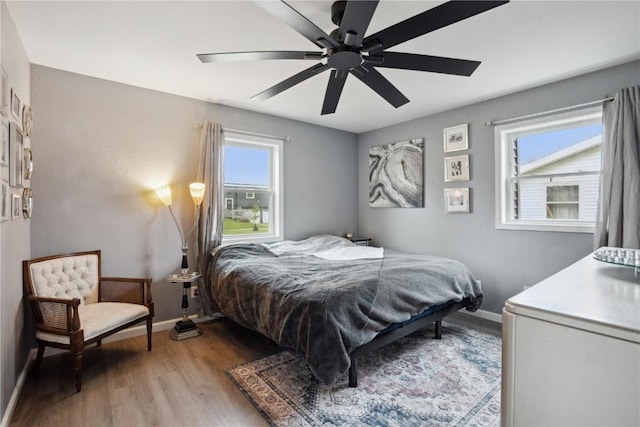 3007 Ravenwood Ter NW, Cedar Rapids, IA 52405 - bedroom featuring light wood-type flooring, baseboards, and ceiling fan