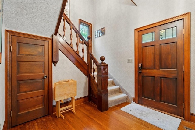205 S Ford St, Anamosa, IA 52205 - entrance foyer with wood finished floors, stairway, and baseboards