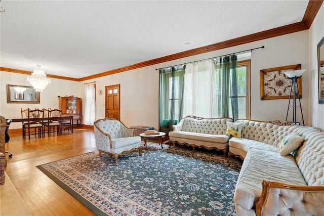 205 S Ford St, Anamosa, IA 52205 - living area featuring a chandelier, crown molding, hardwood / wood-style floors, and a textured ceiling