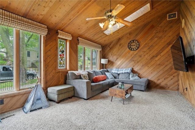 205 S Ford St, Anamosa, IA 52205 - carpeted living area featuring wood walls, wooden ceiling, and a ceiling fan
