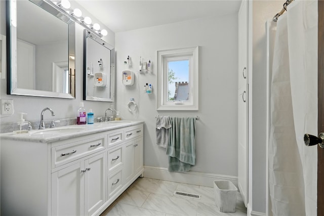 205 S Ford St, Anamosa, IA 52205 - bathroom featuring marble look tile flooring and double vanity