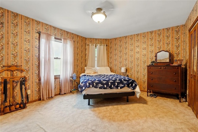 205 S Ford St, Anamosa, IA 52205 - bedroom featuring carpet flooring, wallpapered walls, and a closet