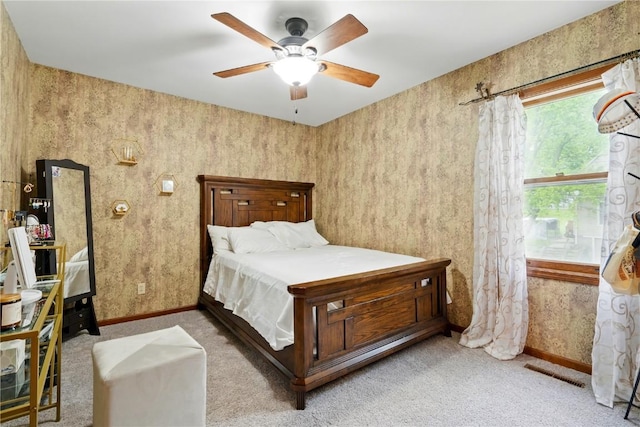 205 S Ford St, Anamosa, IA 52205 - carpeted bedroom with baseboards and ceiling fan