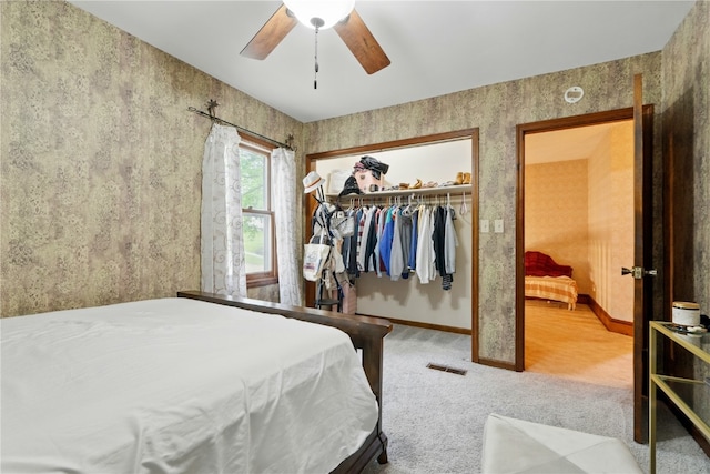 205 S Ford St, Anamosa, IA 52205 - bedroom featuring carpet, a closet, baseboards, and a ceiling fan