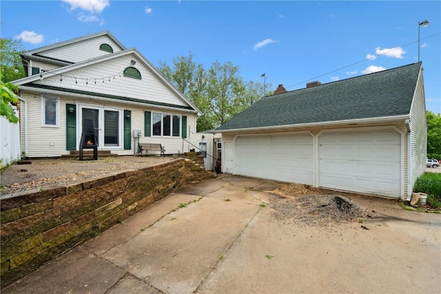 205 S Ford St, Anamosa, IA 52205 - view of front of house featuring a detached garage, an outbuilding, and entry steps