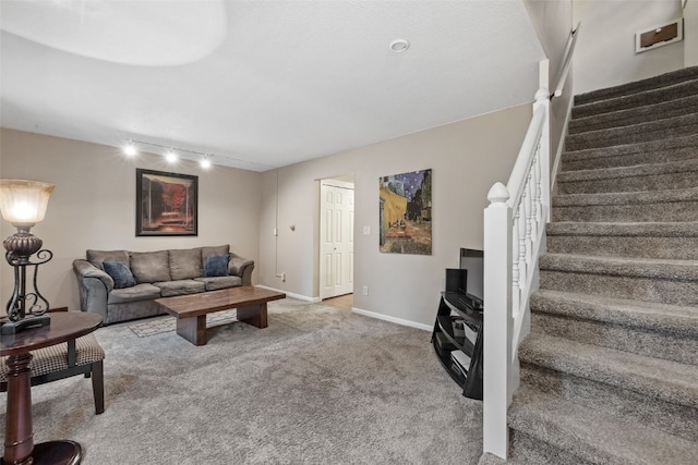 3051 Wayne Ave Unit 64, Iowa City, IA 52240 - living room featuring stairway, rail lighting, carpet flooring, and baseboards