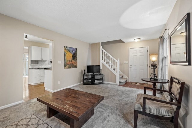 3051 Wayne Ave Unit 64, Iowa City, IA 52240 - living room with light carpet, stairs, and baseboards