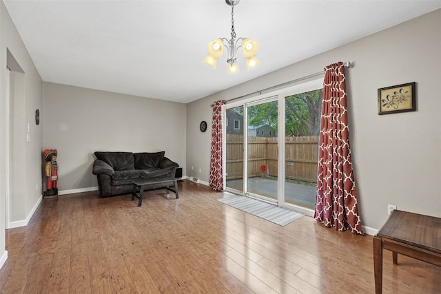 3051 Wayne Ave Unit 64, Iowa City, IA 52240 - living area with wood finished floors, a chandelier, and baseboards