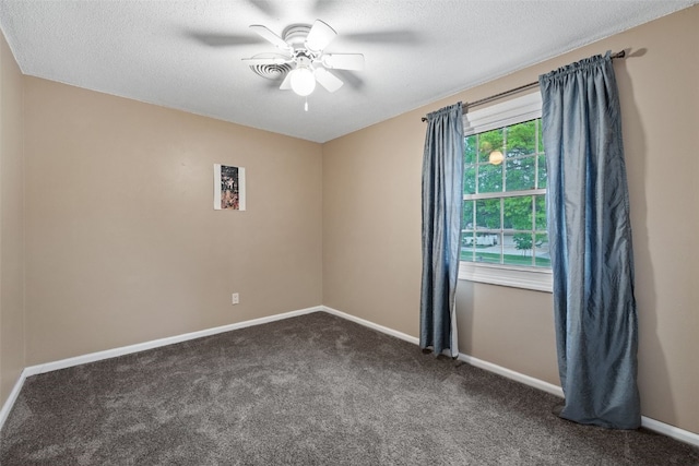 3051 Wayne Ave Unit 64, Iowa City, IA 52240 - spare room with ceiling fan, dark colored carpet, baseboards, and a textured ceiling
