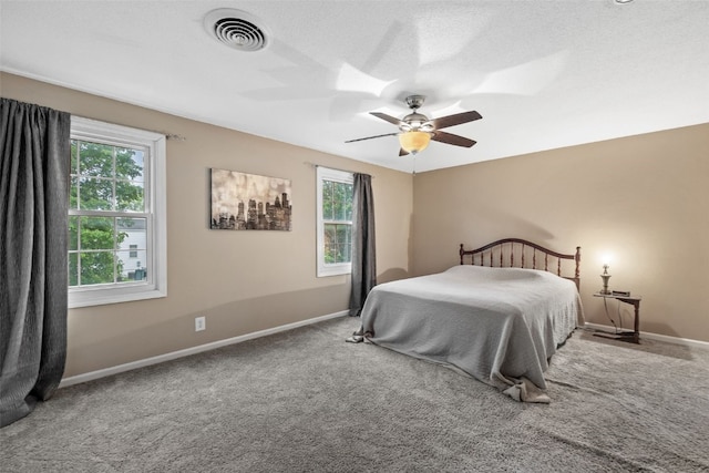 3051 Wayne Ave Unit 64, Iowa City, IA 52240 - carpeted bedroom featuring baseboards and a ceiling fan