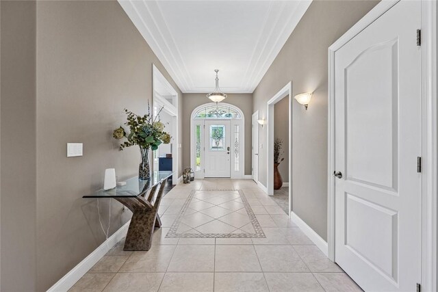 6712 Spring Grove Ct NE, Cedar Rapids, IA 52411 - entryway featuring baseboards, light tile patterned floors, crown molding, and inlaid floor details