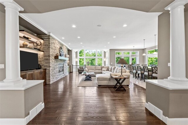 6712 Spring Grove Ct NE, Cedar Rapids, IA 52411 - living room with ornate columns, recessed lighting, a fireplace, and dark wood-type flooring