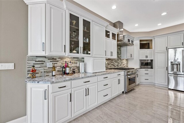 6712 Spring Grove Ct NE, Cedar Rapids, IA 52411 - kitchen with premium appliances, wall chimney exhaust hood, backsplash, light stone countertops, and recessed lighting