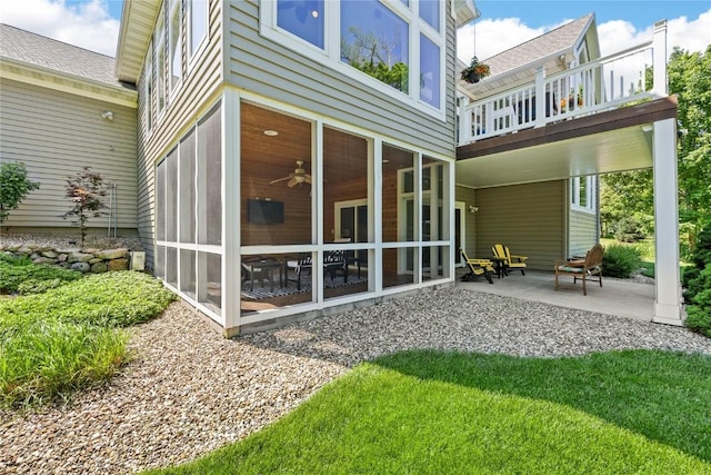 6712 Spring Grove Ct NE, Cedar Rapids, IA 52411 - rear view of house featuring a sunroom, roof with shingles, and a ceiling fan