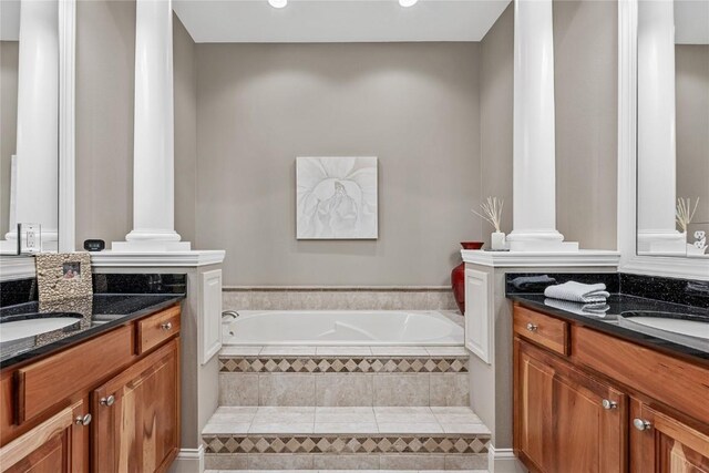 6712 Spring Grove Ct NE, Cedar Rapids, IA 52411 - bathroom featuring decorative columns, vanity, a garden tub, and recessed lighting