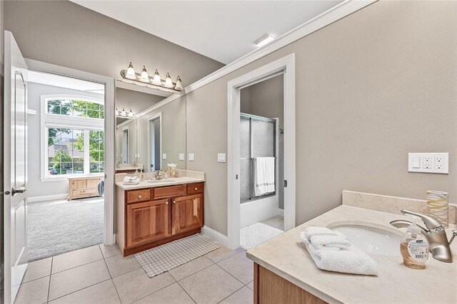 6712 Spring Grove Ct NE, Cedar Rapids, IA 52411 - bathroom with vanity, tile patterned flooring, baseboards, and enclosed tub / shower combo