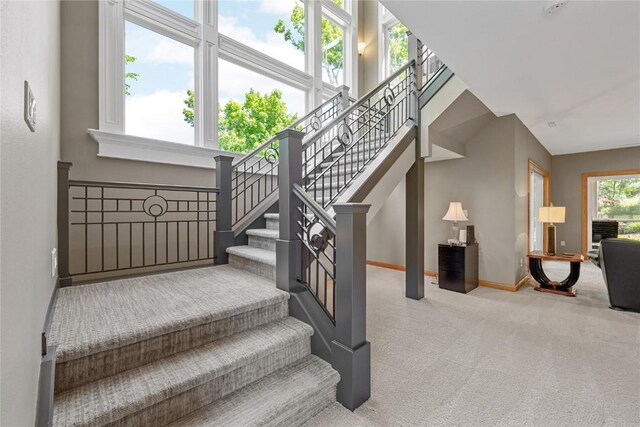 6712 Spring Grove Ct NE, Cedar Rapids, IA 52411 - stairs with carpet floors and baseboards