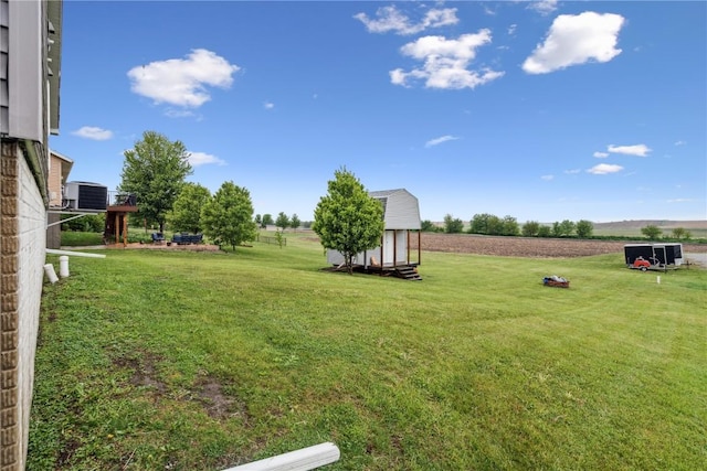 912 N St, Williamsburg, IA 52361 - view of green lawn featuring cooling unit and a view of rural / pastoral area