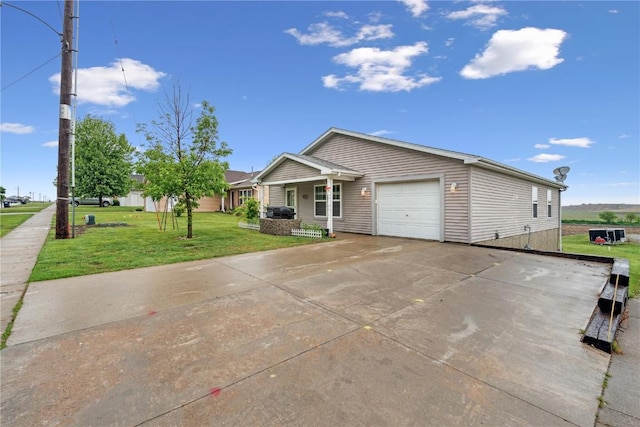 912 N St, Williamsburg, IA 52361 - ranch-style house with an attached garage, a front yard, concrete driveway, and covered porch
