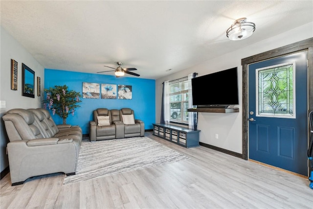 912 N St, Williamsburg, IA 52361 - living area featuring ceiling fan, wood finished floors, and baseboards