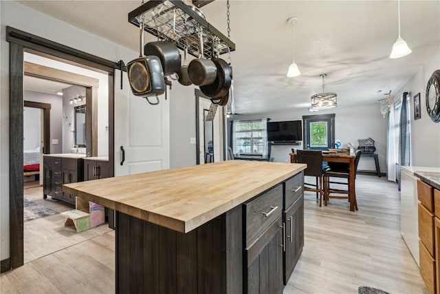 912 N St, Williamsburg, IA 52361 - kitchen with butcher block countertops, light wood finished floors, and decorative light fixtures