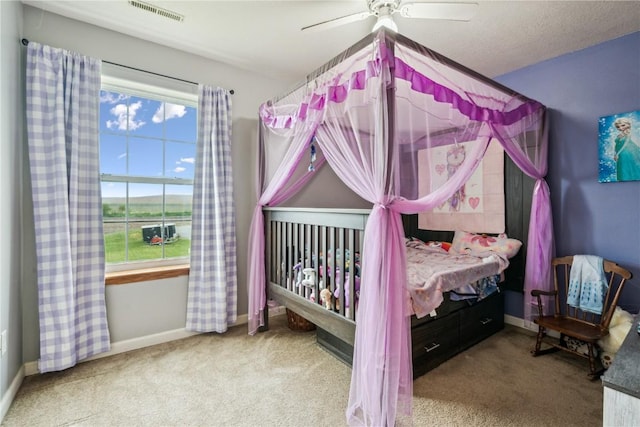 912 N St, Williamsburg, IA 52361 - carpeted bedroom featuring baseboards and ceiling fan