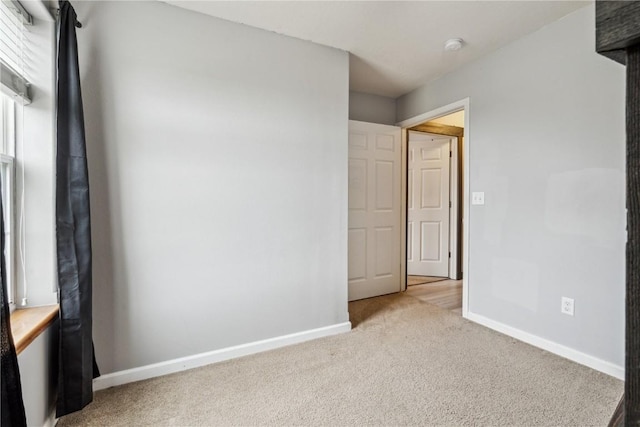 912 N St, Williamsburg, IA 52361 - spare room with baseboards and light colored carpet