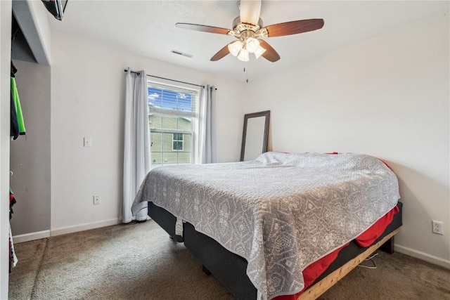 912 N St, Williamsburg, IA 52361 - carpeted bedroom featuring baseboards and ceiling fan